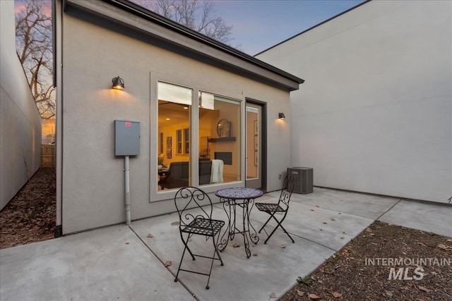 view of patio featuring central air condition unit and fence