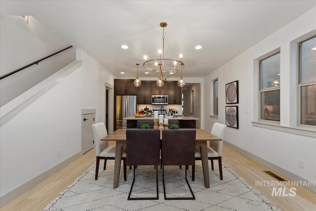 dining area featuring visible vents, a notable chandelier, recessed lighting, and light wood-type flooring