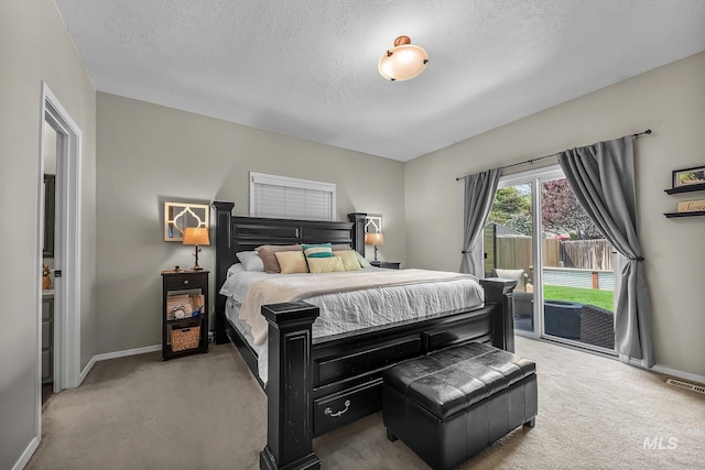 bedroom featuring baseboards, access to outside, carpet, and visible vents