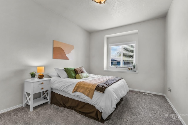 carpeted bedroom with baseboards and visible vents