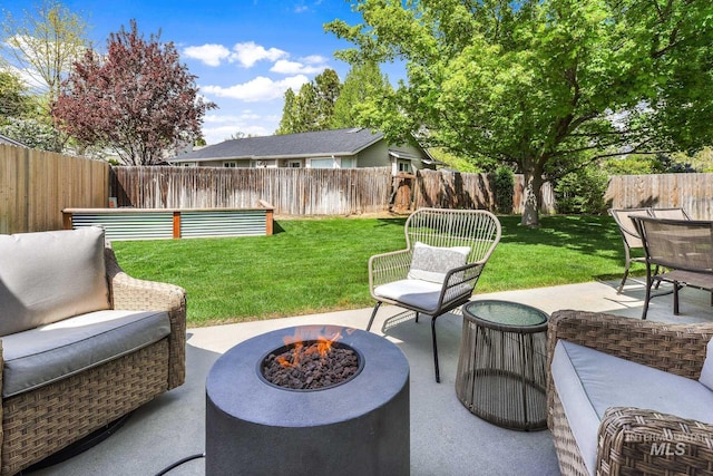 view of patio / terrace with a fenced backyard and a fire pit