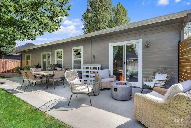view of patio with fence and an outdoor fire pit