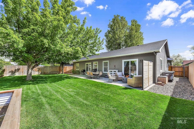 back of property featuring a lawn, a fenced backyard, an outdoor living space, and a patio