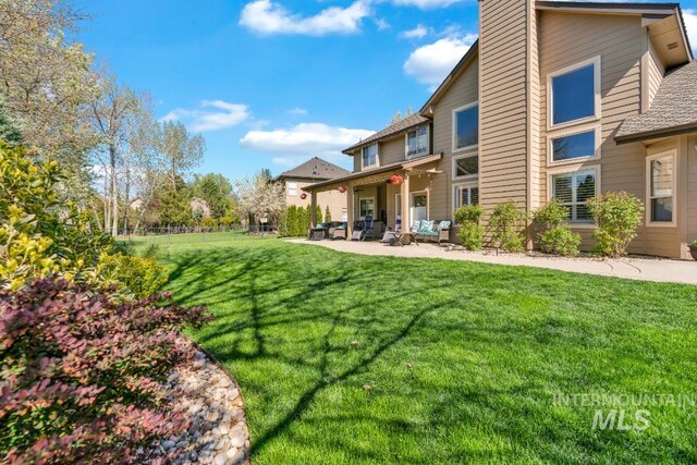1645 S River Grove Way, Eagle, ID 83616 - exterior space featuring a front lawn, fence, outdoor lounge area, a shingled roof, and a patio