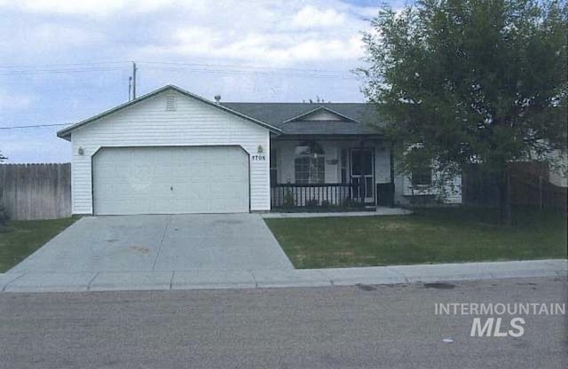 ranch-style house featuring a porch, a garage, and a front yard