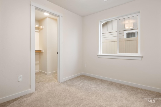 spare room featuring light colored carpet