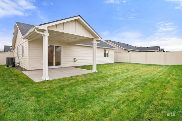 rear view of property with central AC unit, a yard, and a patio