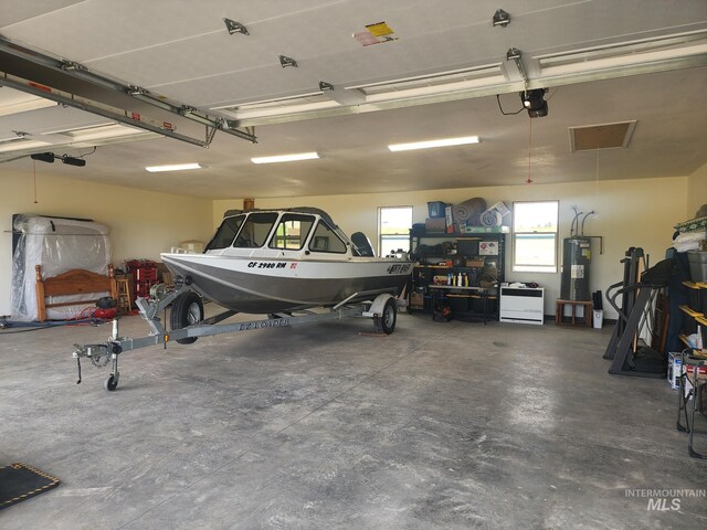 garage with water heater and a garage door opener