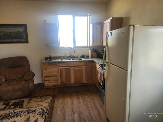 kitchen featuring sink, white fridge, dark hardwood / wood-style flooring, and electric stove