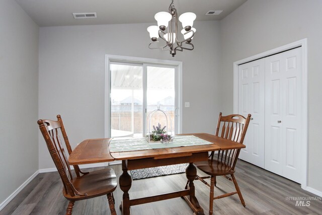 dining room featuring dark hardwood / wood-style floors and a chandelier