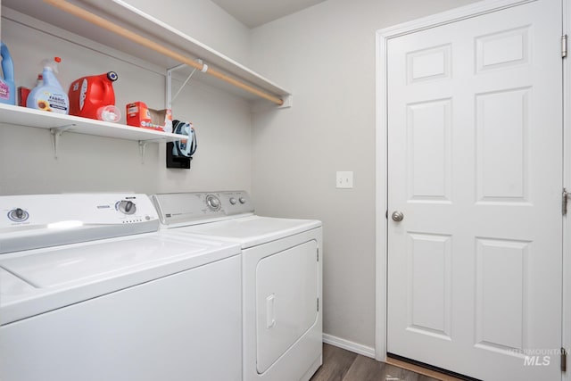 washroom featuring dark hardwood / wood-style floors and washer and clothes dryer