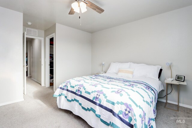 bedroom featuring light colored carpet and ceiling fan