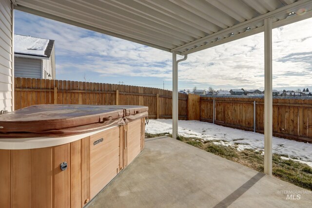 view of patio / terrace with a hot tub