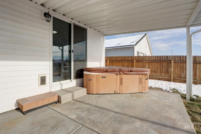 view of patio / terrace with a hot tub