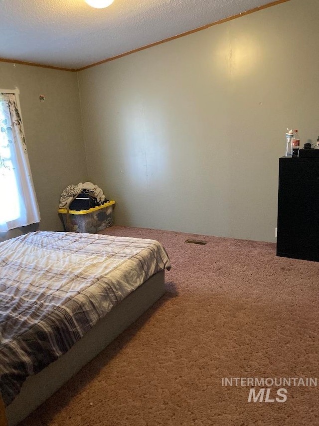 776 16th St, Vale, OR 97918 - carpeted bedroom featuring ornamental molding and a textured ceiling