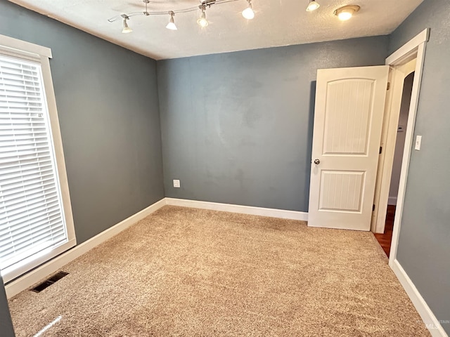 unfurnished room featuring carpet