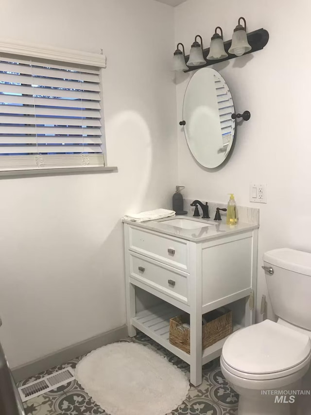 640 Roosevelt Ave, Grand View, ID 83624 - bathroom featuring vanity, toilet, and baseboards