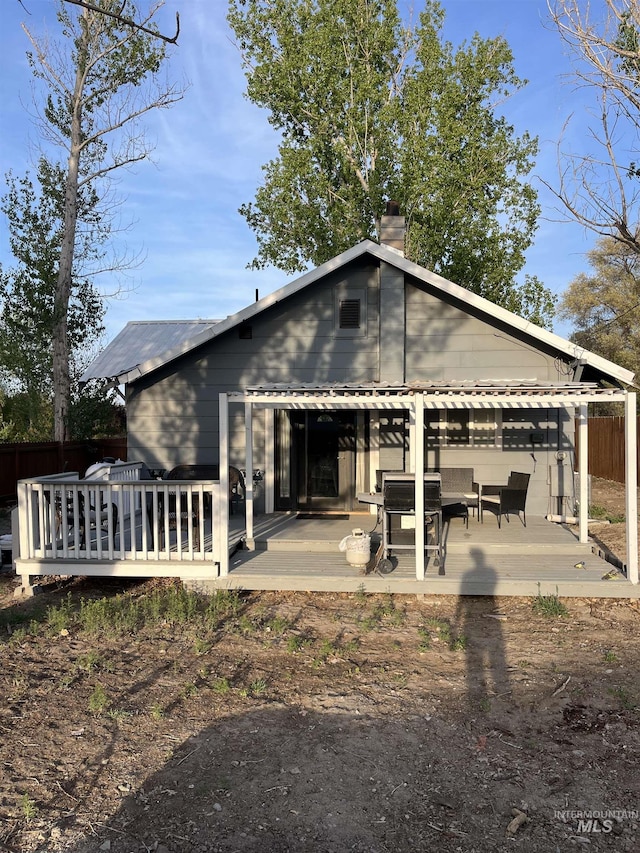 640 Roosevelt Ave, Grand View, ID 83624 - back of house featuring fence, a deck, and a chimney