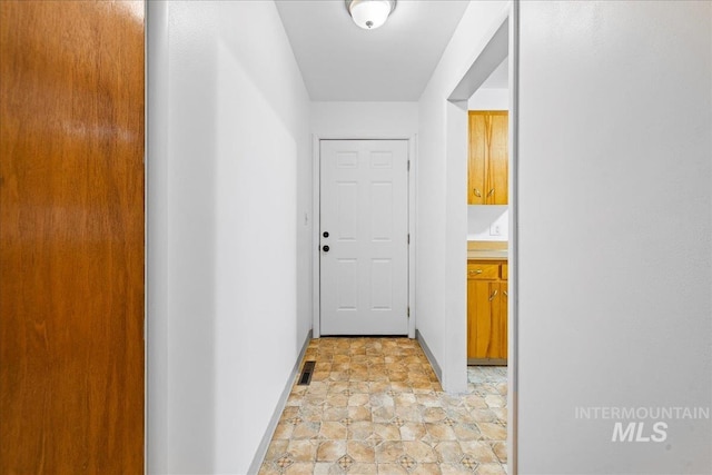 corridor featuring visible vents and baseboards