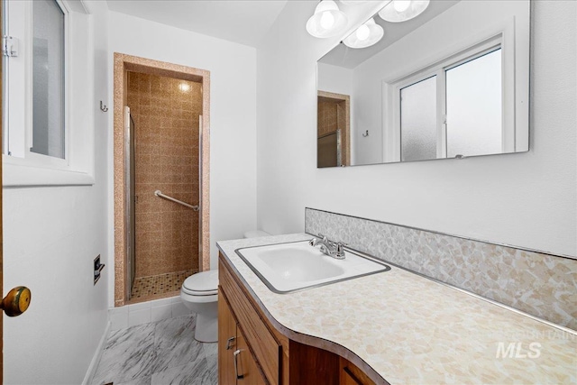 full bath with baseboards, toilet, a stall shower, marble finish floor, and vanity