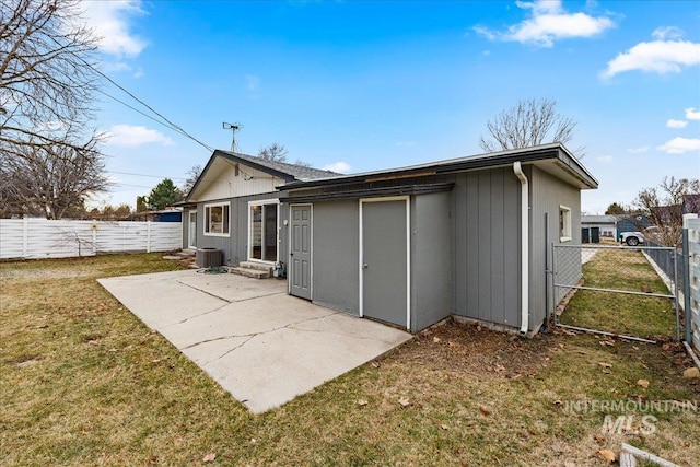 back of house featuring a patio, a yard, a fenced backyard, entry steps, and central air condition unit