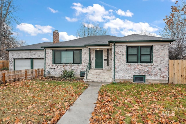 92 N Yale St, Nampa, ID 83651 - view of front facade featuring a front lawn, a garage, a chimney, brick siding, and fence