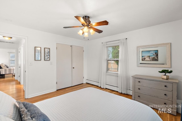 92 N Yale St, Nampa, ID 83651 - bedroom featuring light wood-style flooring, a baseboard heating unit, baseboards, visible vents, and a ceiling fan