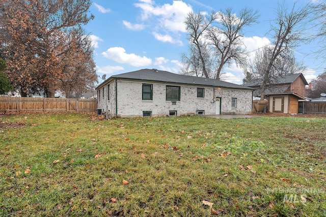 92 N Yale St, Nampa, ID 83651 - rear view of house with a yard, an outbuilding, a patio, and a fenced backyard