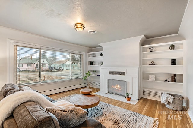 92 N Yale St, Nampa, ID 83651 - living room featuring a fireplace with flush hearth, visible vents, crown molding, and light wood finished floors