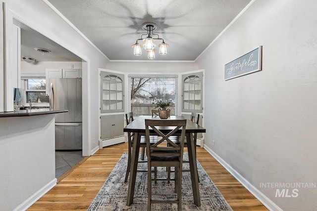 92 N Yale St, Nampa, ID 83651 - dining room with a baseboard radiator, a wealth of natural light, and ornamental molding