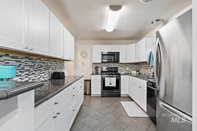 92 N Yale St, Nampa, ID 83651 - kitchen featuring white cabinets, tasteful backsplash, light tile patterned flooring, and appliances with stainless steel finishes
