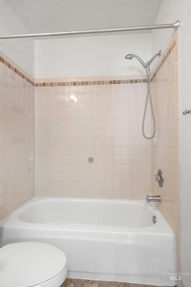 bathroom with bathtub / shower combination and toilet