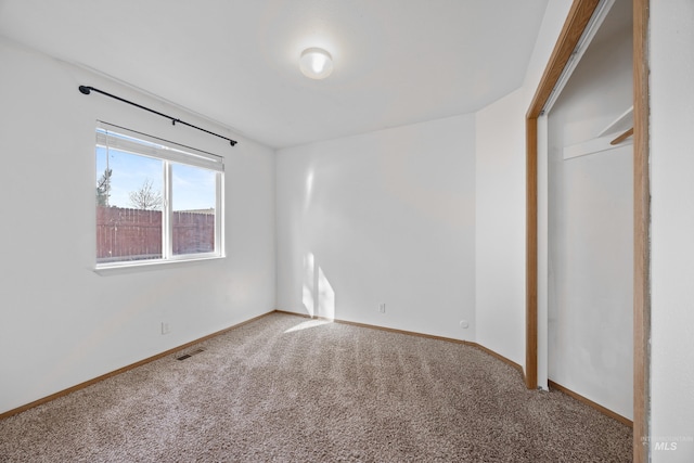 unfurnished bedroom featuring visible vents, baseboards, and carpet floors