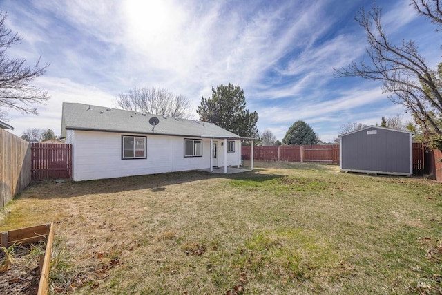 back of property featuring a yard, a fenced backyard, an outdoor structure, a storage unit, and a patio area