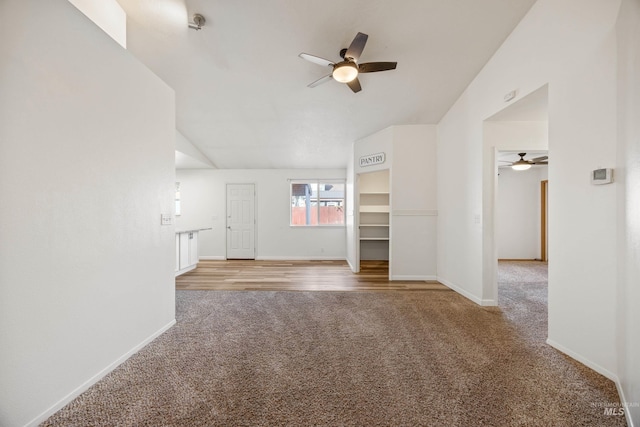 unfurnished living room with baseboards, light carpet, and a ceiling fan