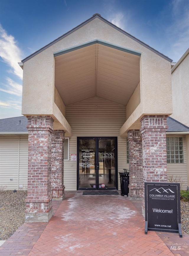 property entrance featuring brick siding