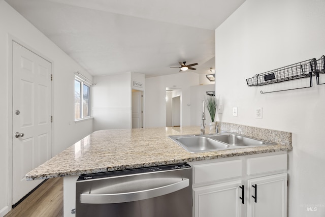 kitchen with ceiling fan, dishwasher, a peninsula, white cabinets, and a sink