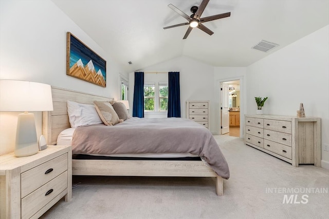 bedroom with light carpet, ensuite bath, ceiling fan, and lofted ceiling