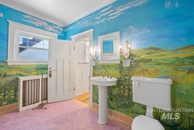 bathroom featuring toilet, wallpapered walls, and baseboards