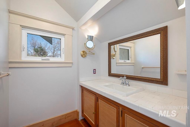 bathroom featuring vanity and vaulted ceiling