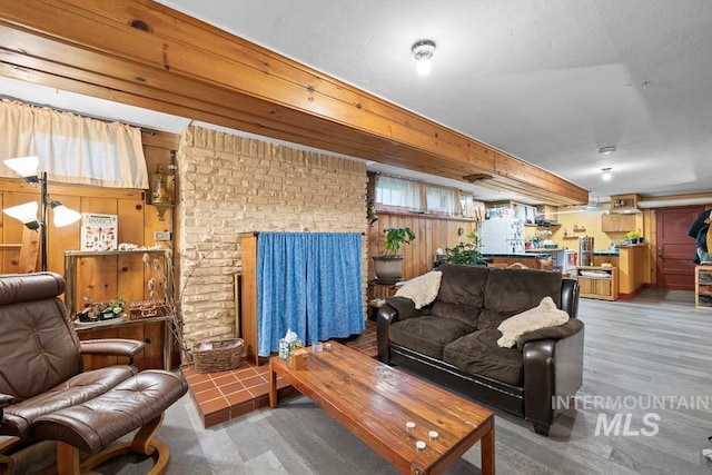 living room with wood walls and wood finished floors