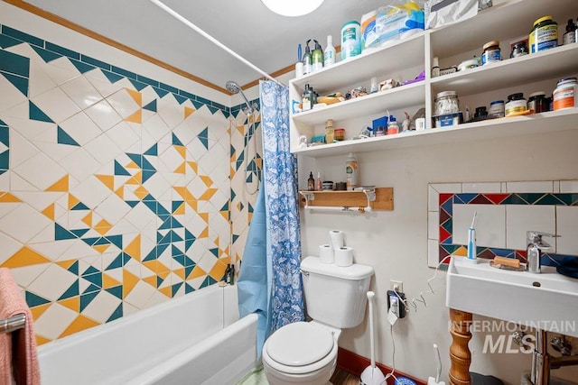 full bathroom with shower / bath combination with curtain, a sink, and toilet