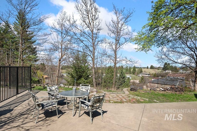 view of patio / terrace featuring outdoor dining space and fence