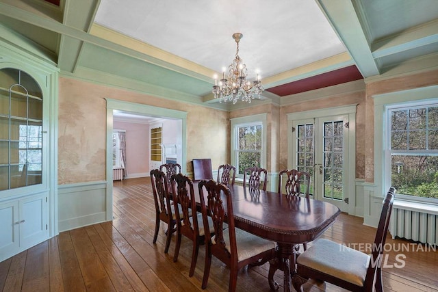 dining area with plenty of natural light, beamed ceiling, and coffered ceiling