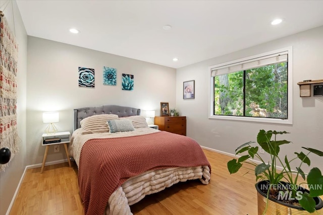 bedroom with baseboards, recessed lighting, and wood finished floors