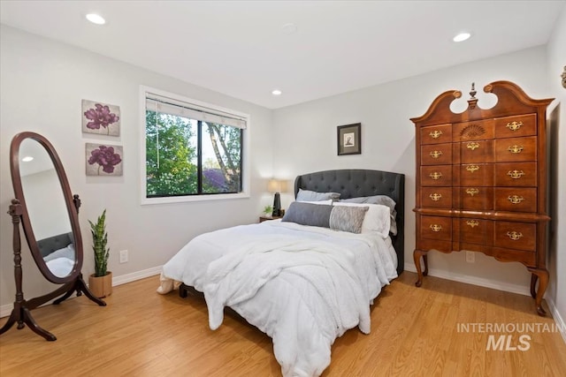 bedroom featuring baseboards, recessed lighting, and light wood-style floors