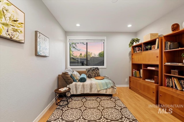 bedroom featuring baseboards, light wood-type flooring, and recessed lighting