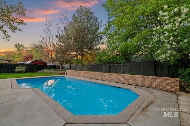 view of pool featuring a patio, a fenced in pool, and a fenced backyard