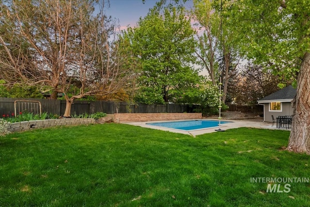 view of pool featuring a fenced in pool, a fenced backyard, a patio area, and a lawn