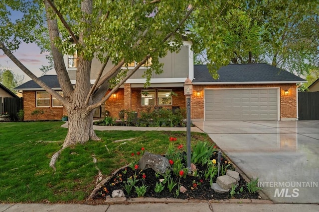 view of front of home with driveway, an attached garage, fence, brick siding, and a front lawn